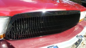 Black holographic metal flake on a grille.