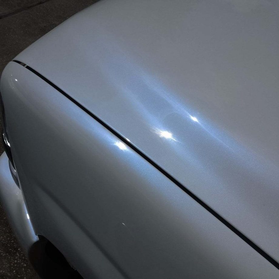 Close up of a white truck with blue ghost pearl