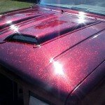Rose Red Metal Flake paint on hood of Ford Explorer.