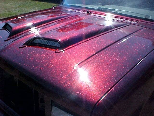 Rose Red Metal Flake paint on hood of Ford Explorer.