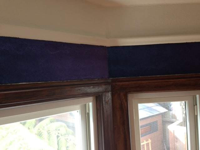 Bay window showing difference in colors on chameleon faux finish wall.