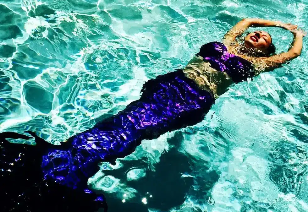 Mermaid with a Red-Blue-Purple silicone tail for swimming.